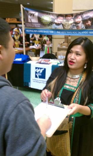 Linda Hawj canvassing at the St. Paul Hmong New Year about the 2012 Election.